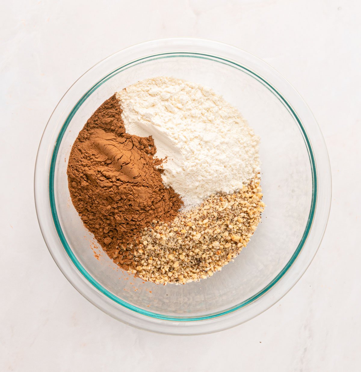 mixing ingredients for linzer cookies in a glass bowl