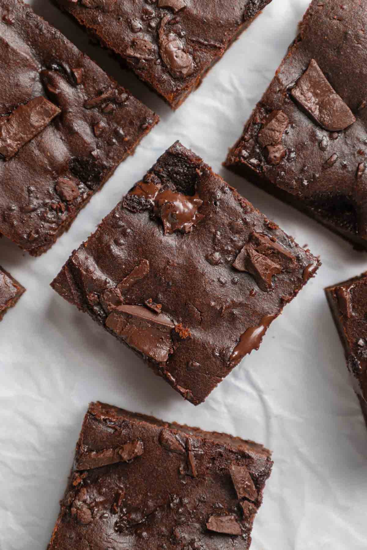 sweet potato brownies cut into squares, ready to eat with melty chocolate