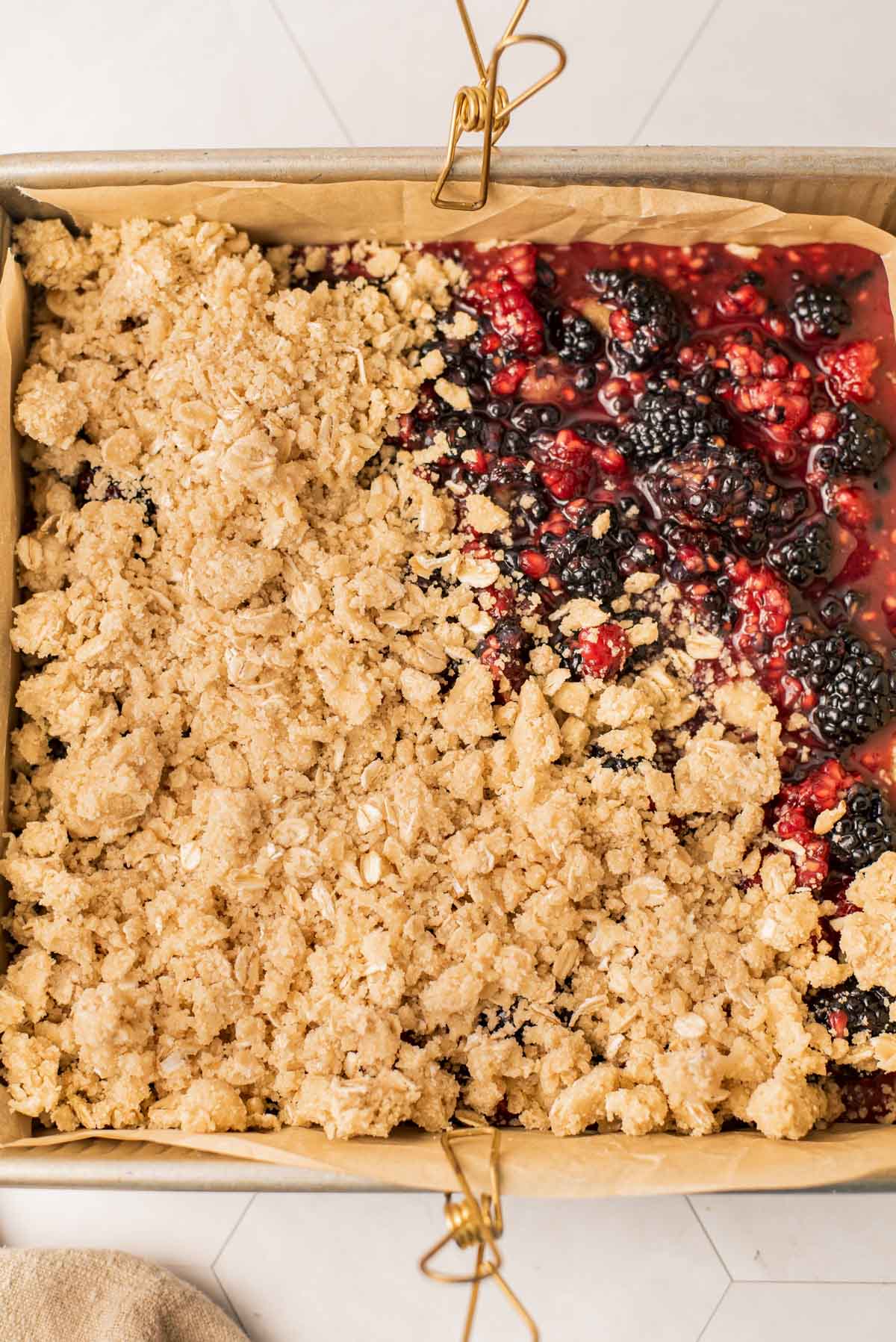 adding shortbread crumble to the top of winter dessert bars