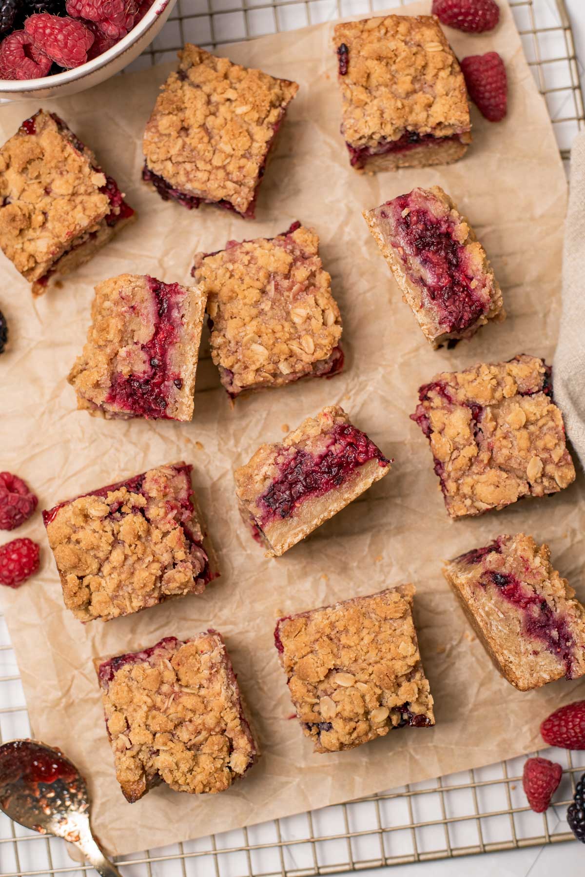 berry shortbtead bars on parchment sheet on a cooling rack