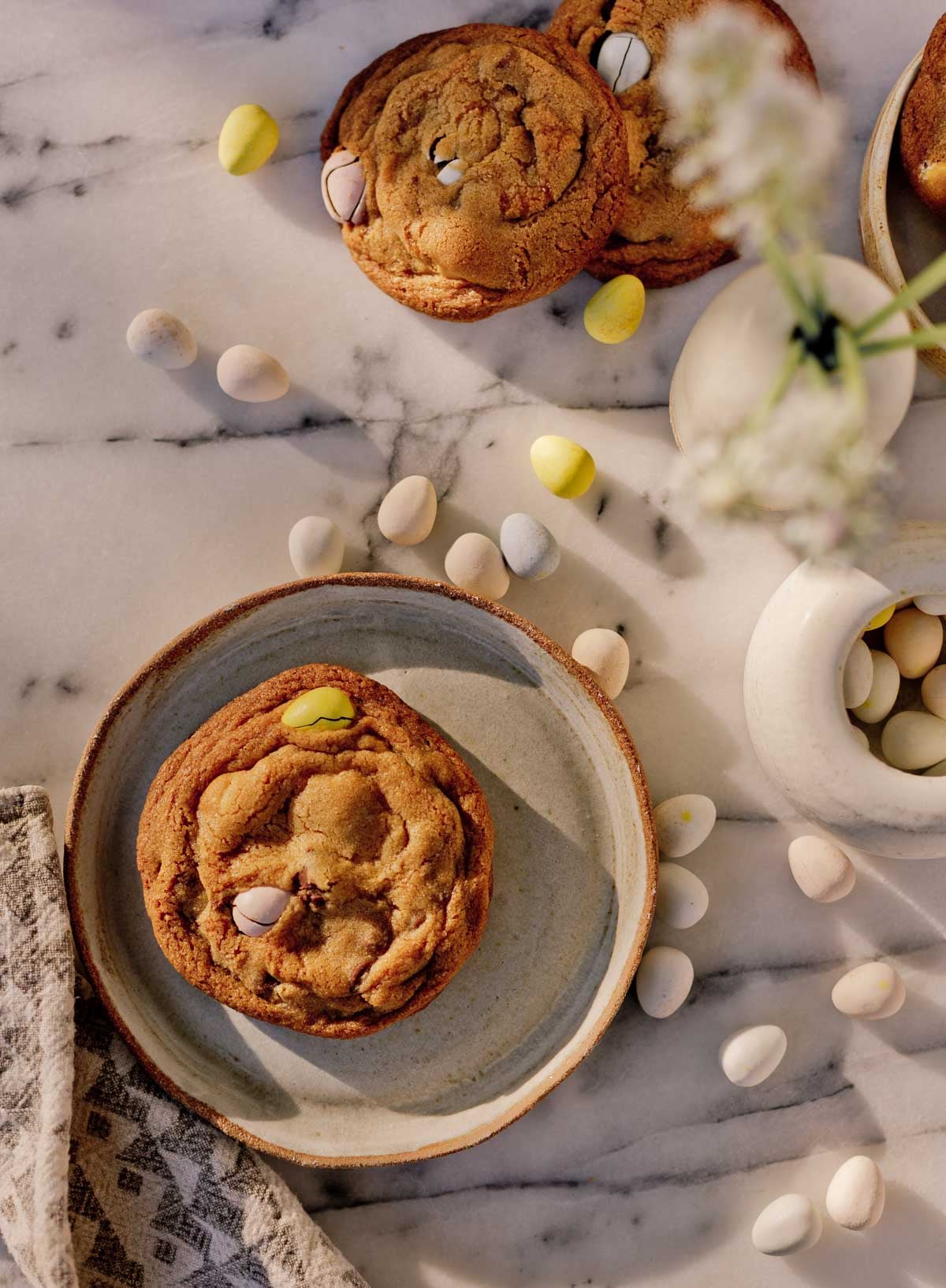 large easter cookie with cadbury chocolate eggs, sitting on marble countertop