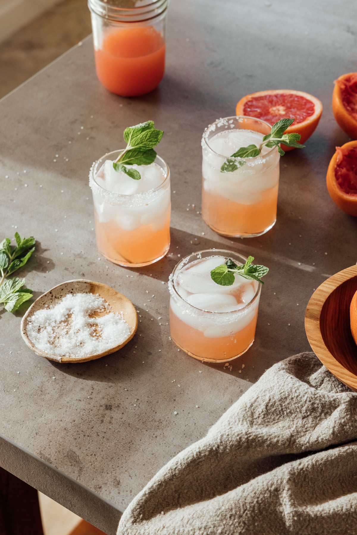 salty dog cocktail drinks with grapefruit on a concrete table